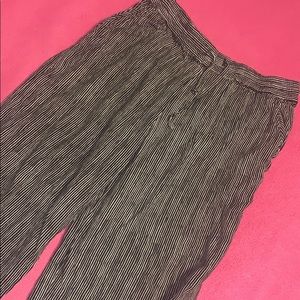 Striped pants, ankle high, loose fitting.